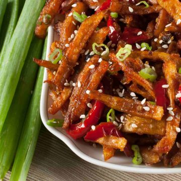 Honey Chilli Potato is a popular Indo-Chinese appetizer. Crispy Fried Potatoes cooked with spring onion and bell peppers in a sweet and spicy sauce.