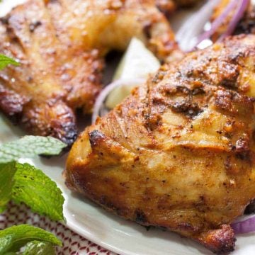 Chicken marinated in yogurt and spices and then baked in an oven. This Indian Tandoori Chicken In Oven recipe is straightforward to make at home with minimal ingredients