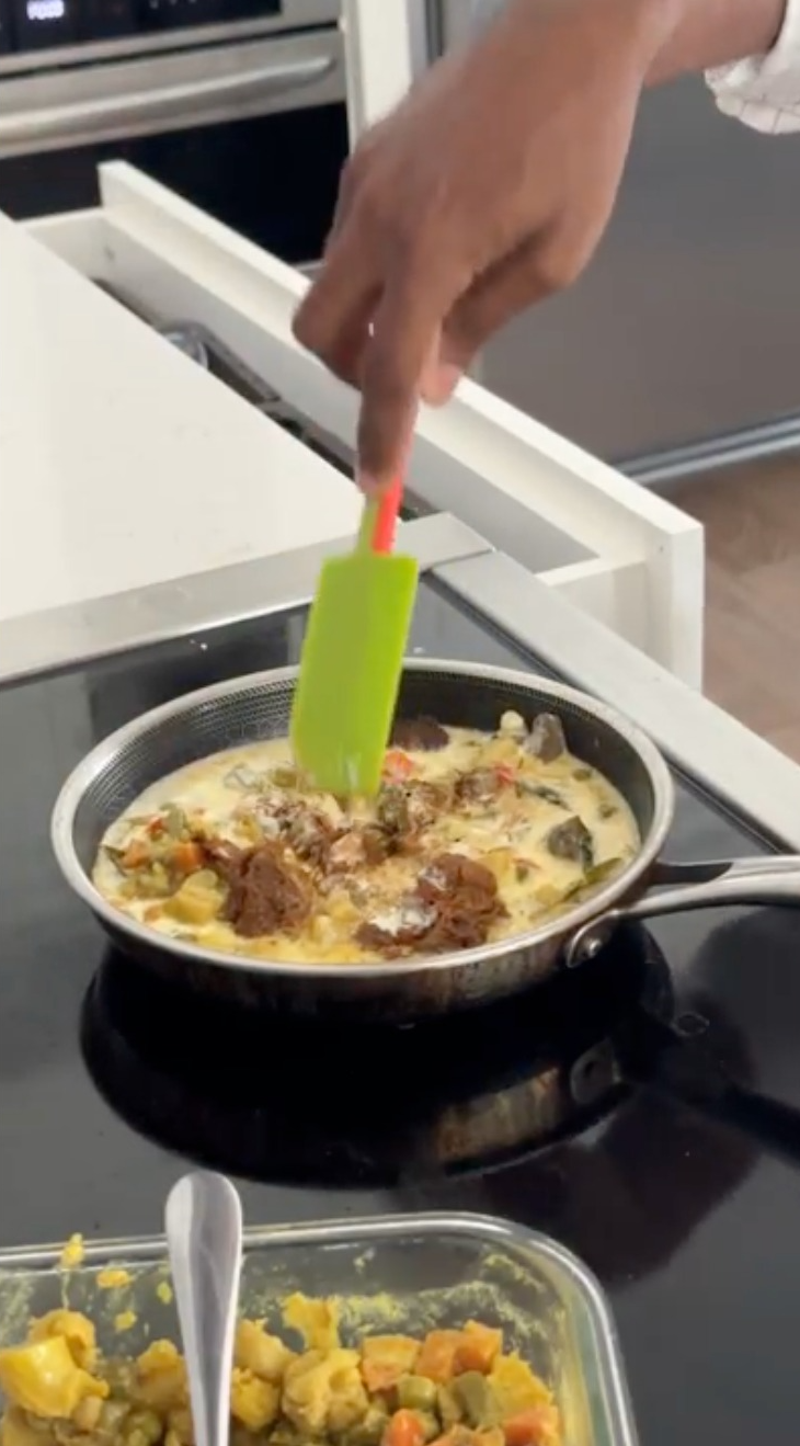 Mixing the gravy with a spatula.